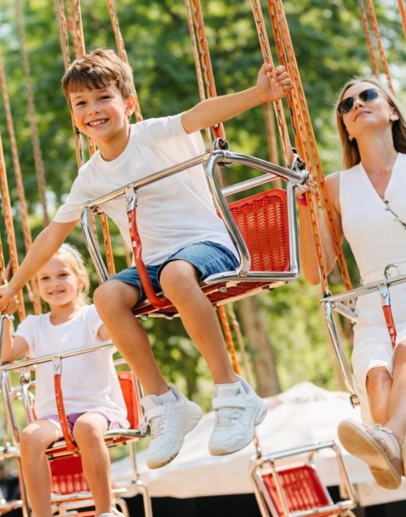 Family enjoying the swing carousel ride at Land of Legends theme park
