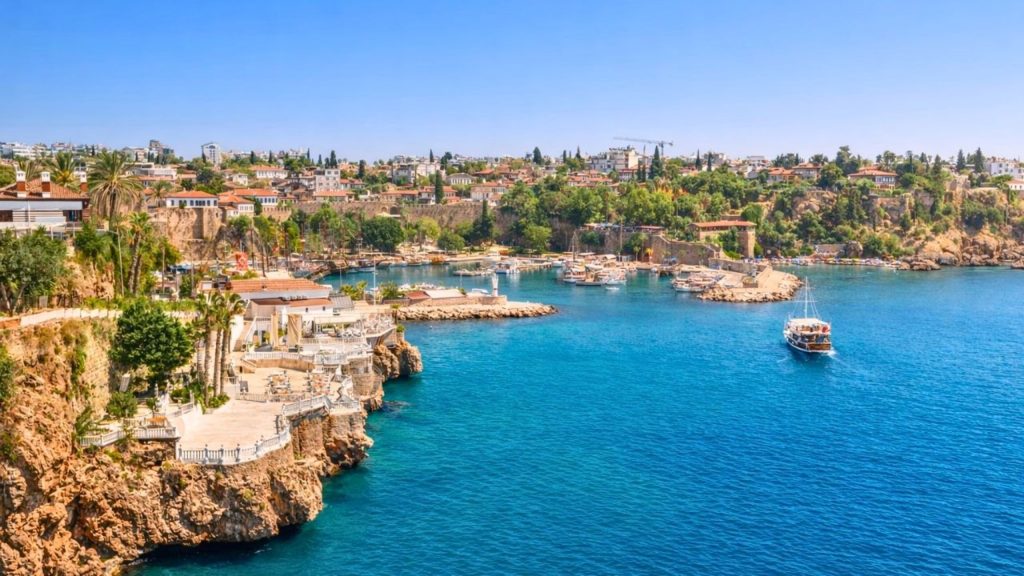 antalya city tour from side kaleici old harbor with boats rocky cliffs and turquoise water
