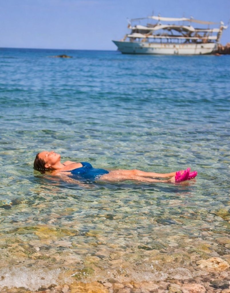 Swimming in crystal-clear shallow water during Mega Star boat tour swimming stop in Antalya