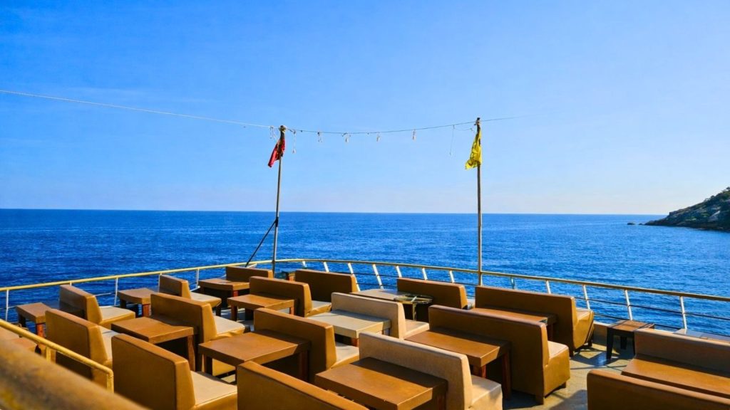 Comfortable open-air seating on Mega Star boat deck with Mediterranean sea view