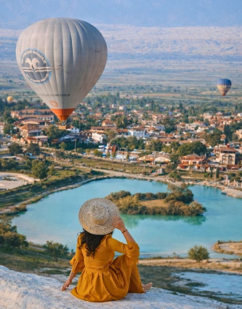 View from Pamukkale travertines with hot air balloon town and lake below during Antalya balloon tour