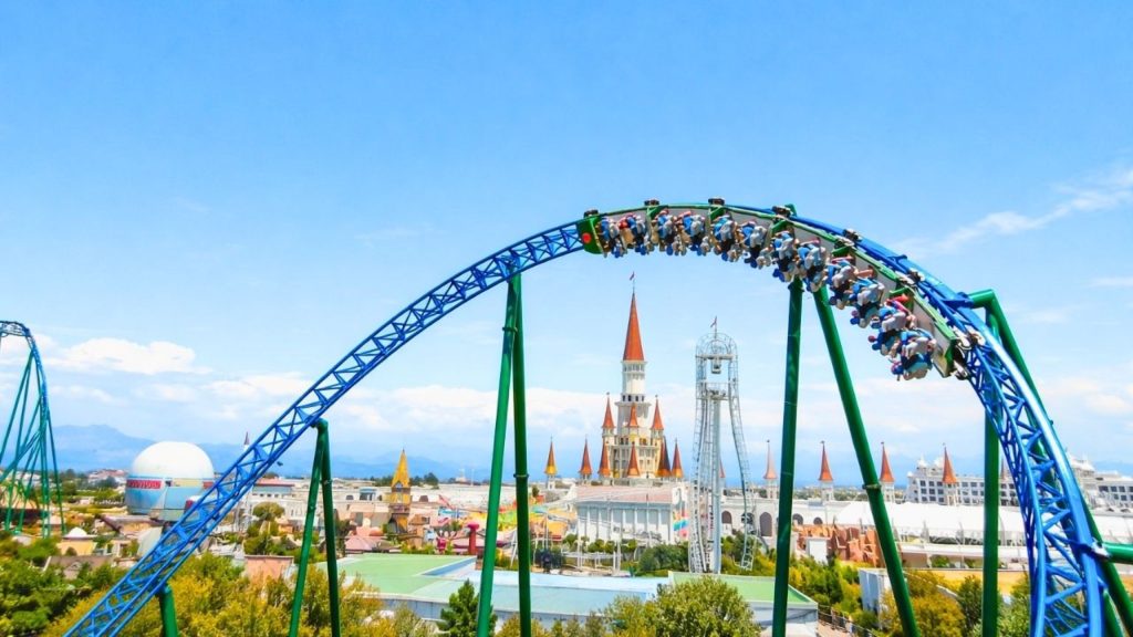 Thrilling roller coaster ride with Land of Legends castle towers in background Antalya