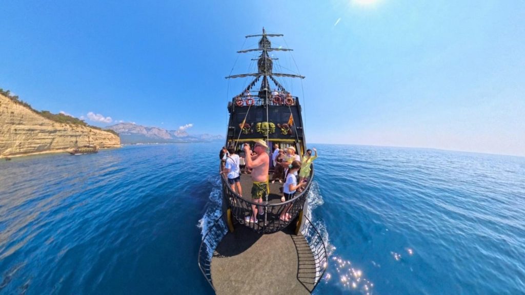 Belek pirate boat trip sailing along Mediterranean coastline cliffs blue water