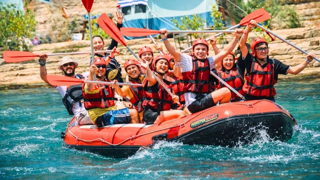 belek rafting crew with paddles raised on turquoise koprulu canyon water