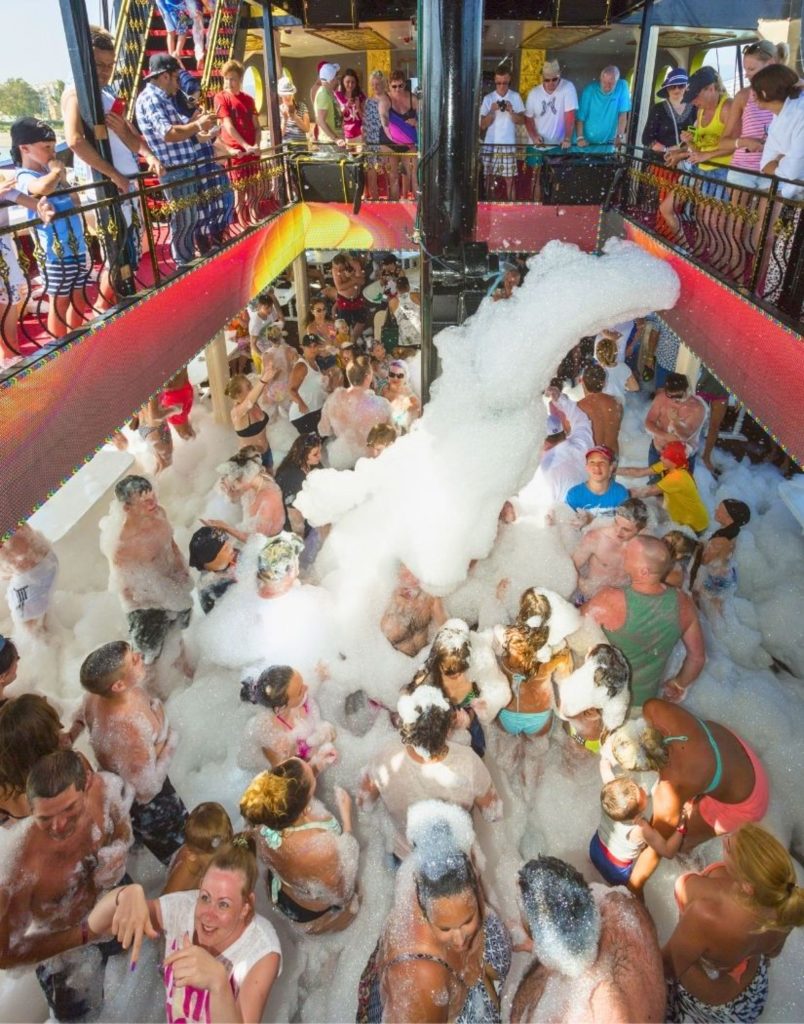 Foam party with music and dancing on the lower deck of Big Kral pirate ship Alanya