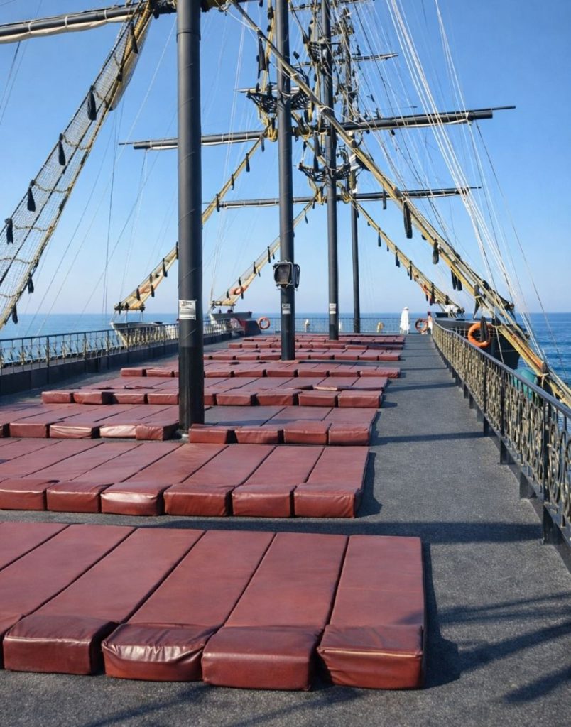 Sundeck with red sun beds on top floor of Big Kral pirate ship Alanya