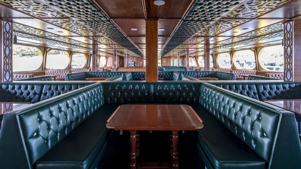 Luxury green leather seating area inside the Big Kral pirate ship Alanya