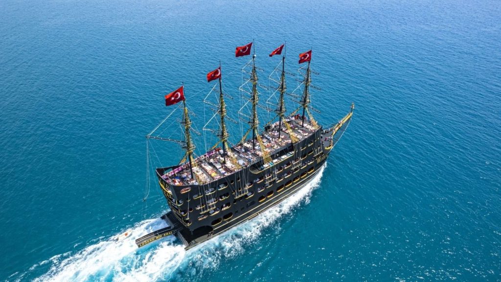 Aerial view of Big Kral pirate ship sailing on blue Mediterranean Sea from Alanya