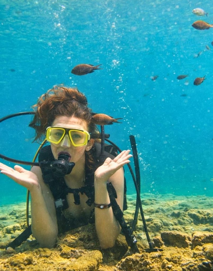 Diver surrounded by colourful fish underwater on Alanya diving tour
