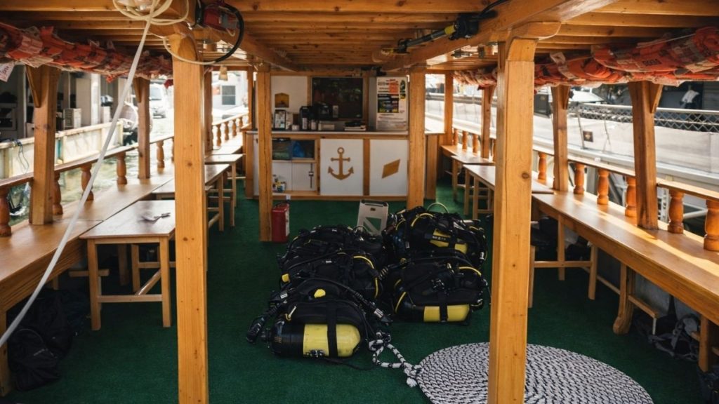 Inside the Alanya diving boat with diving equipment and seating area