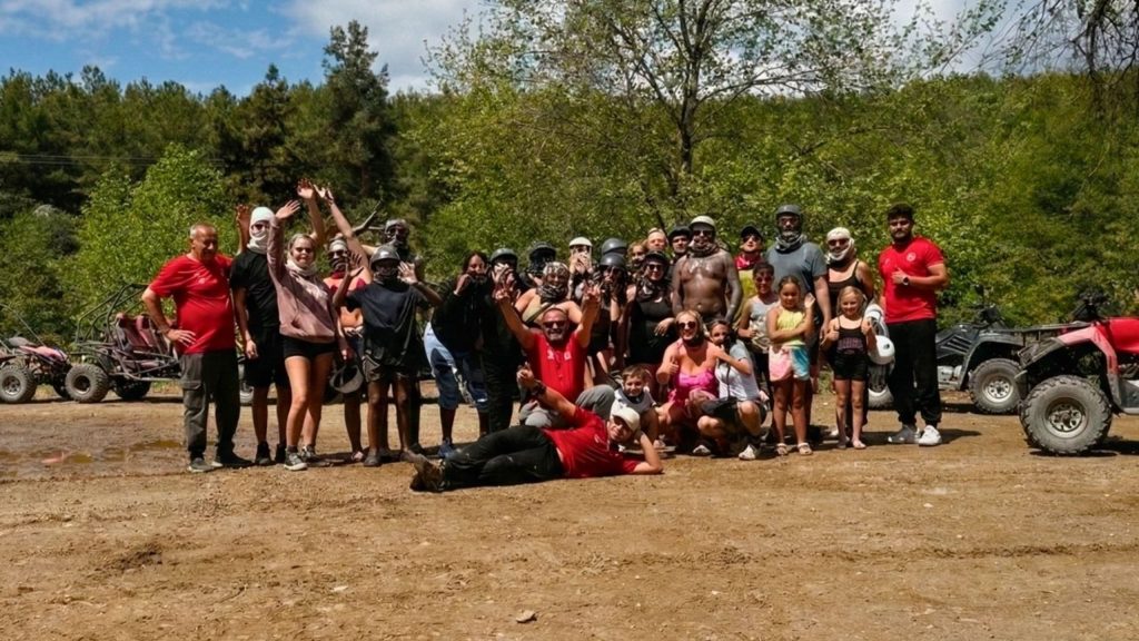 Happy group photo with guides after completing the Alanya quad safari adventure