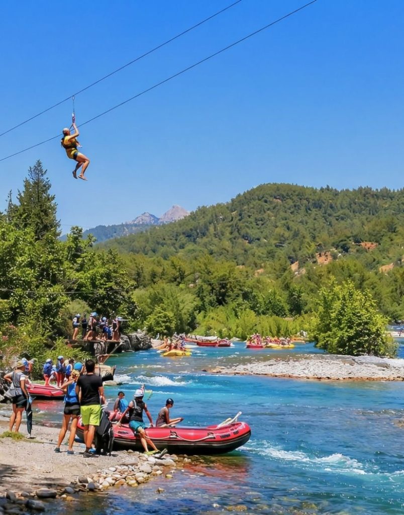 Zipline over turquoise river with rafting boats and green mountains in Koprulu Canyon