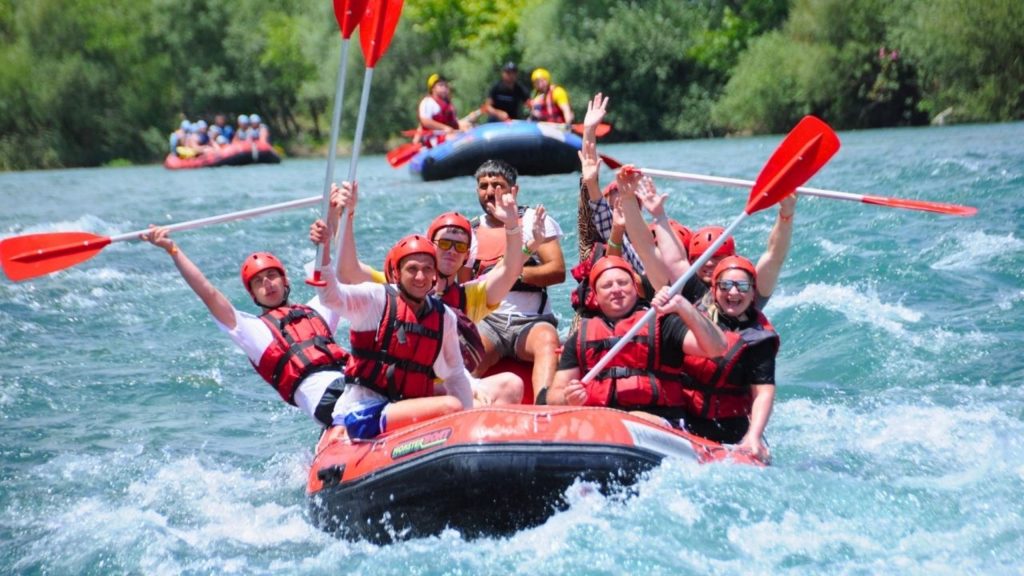 Rafting boat on turquoise river surrounded by green nature near Alanya