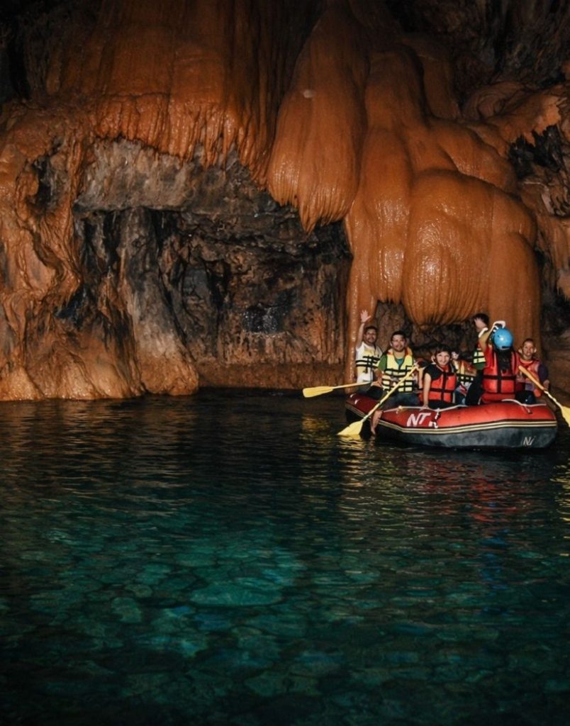side altinbesik cave tour boat ride on the underground lake with massive stalactites above