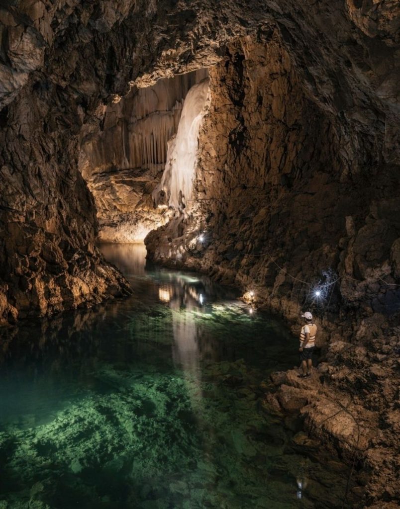 side altinbesik cave tour underground chamber with stalactites and emerald green lake