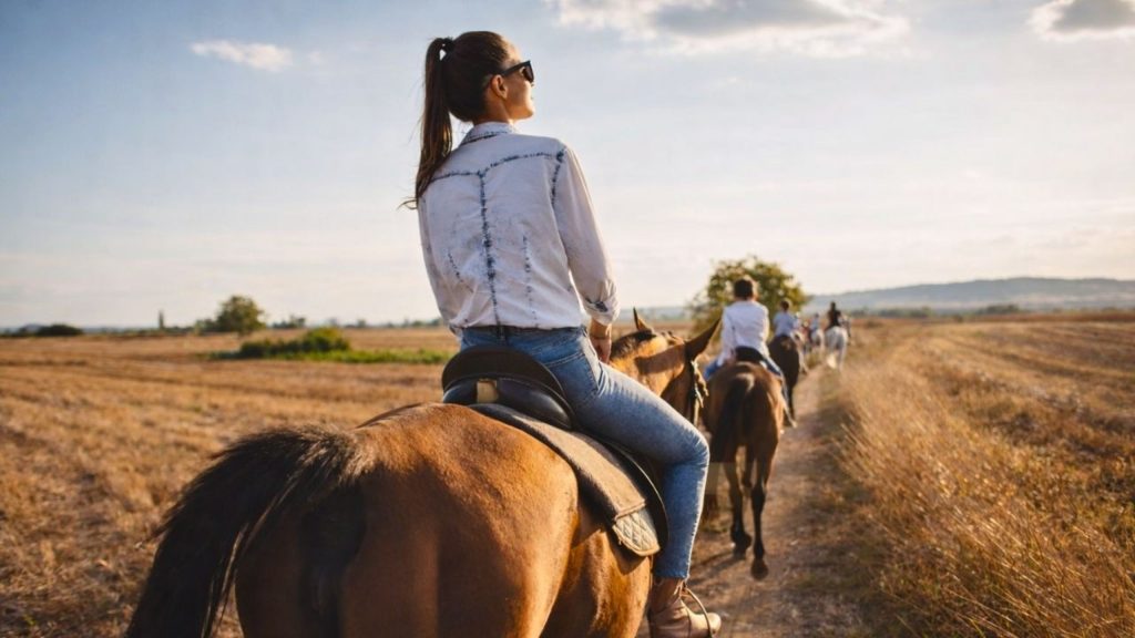 group horse riding through open countryside trails near side manavgat region at sunset