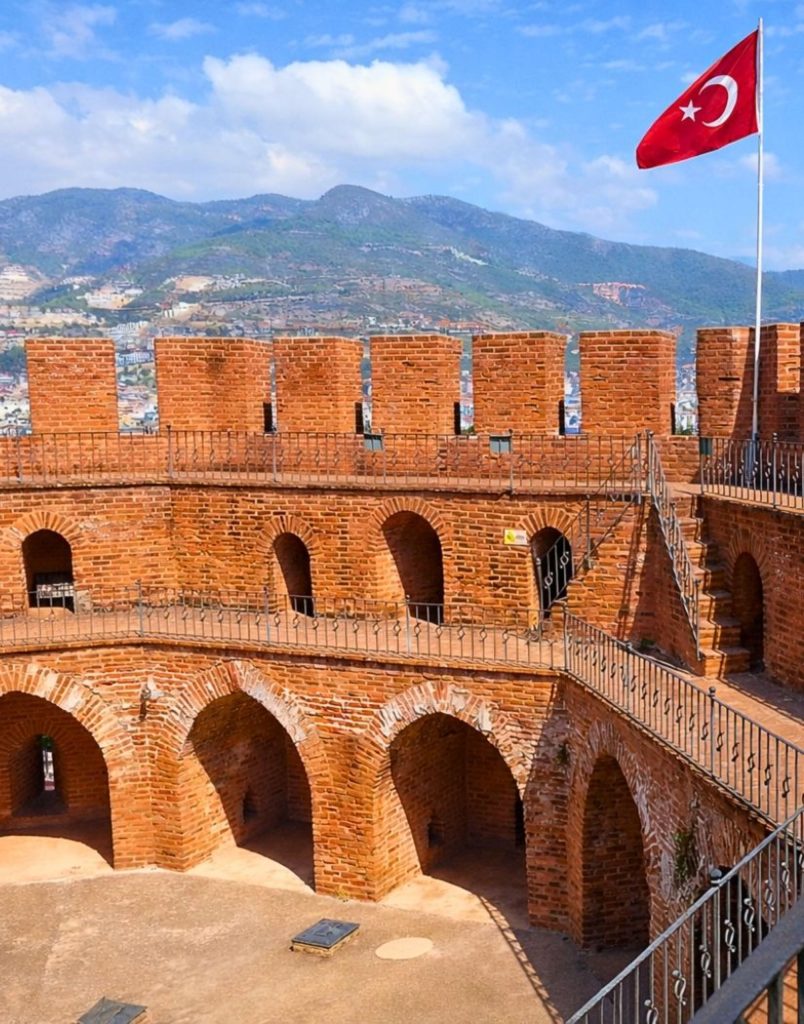 Inside the famous Red Tower of Alanya with Turkish flag brick arches