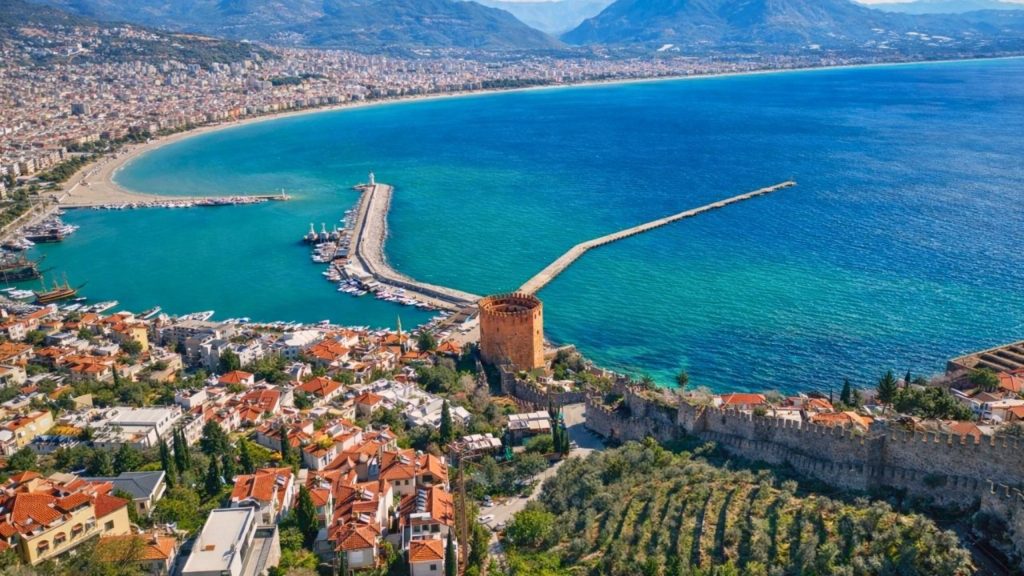 Aerial view of Alanya Red Tower harbour turquoise Mediterranean coastline from castle