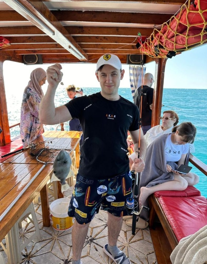 Young visitor proudly showing his catch on the Alanya fishing tour boat