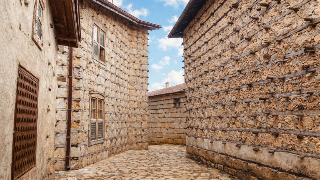 Narrow cobblestone street between traditional stone houses in Taurus Mountain village Alanya tour