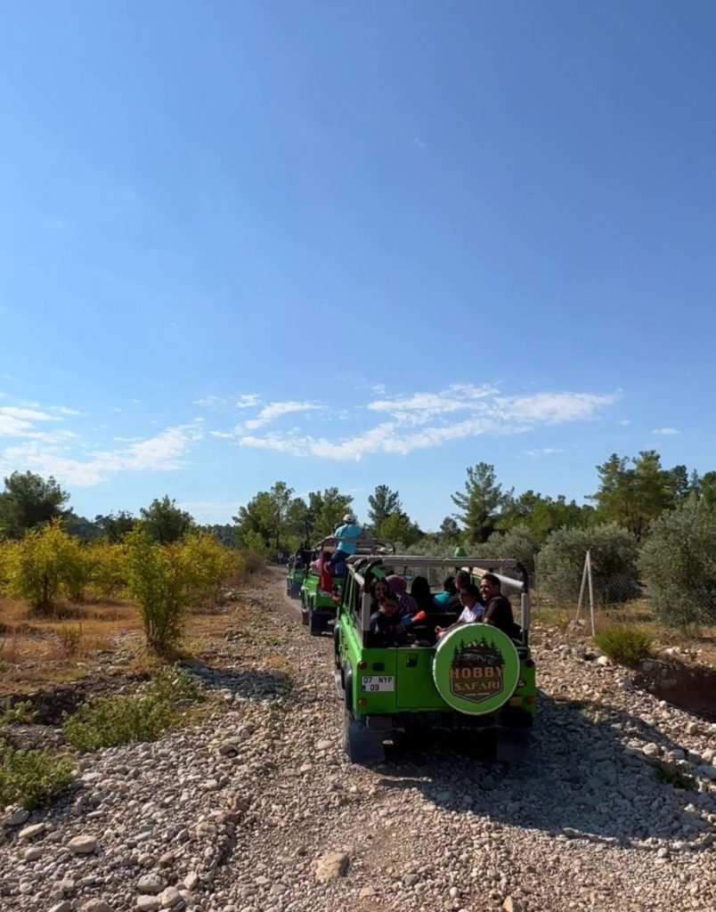Belek jeep safari convoy on rocky off-road trail with olive trees countryside