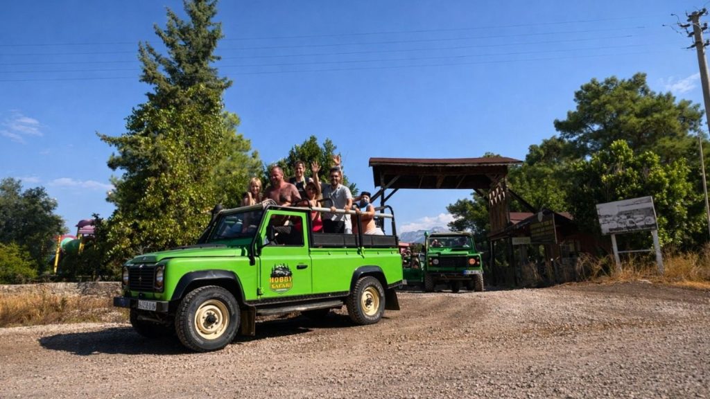 Belek jeep safari Land Rover convoy stop point with pine trees and blue sky