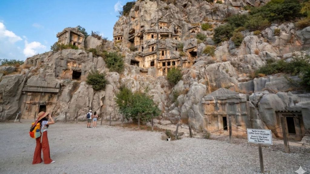 Visitors photographing the Lycian rock tombs of Myra from below on Demre Myra Kekova tour