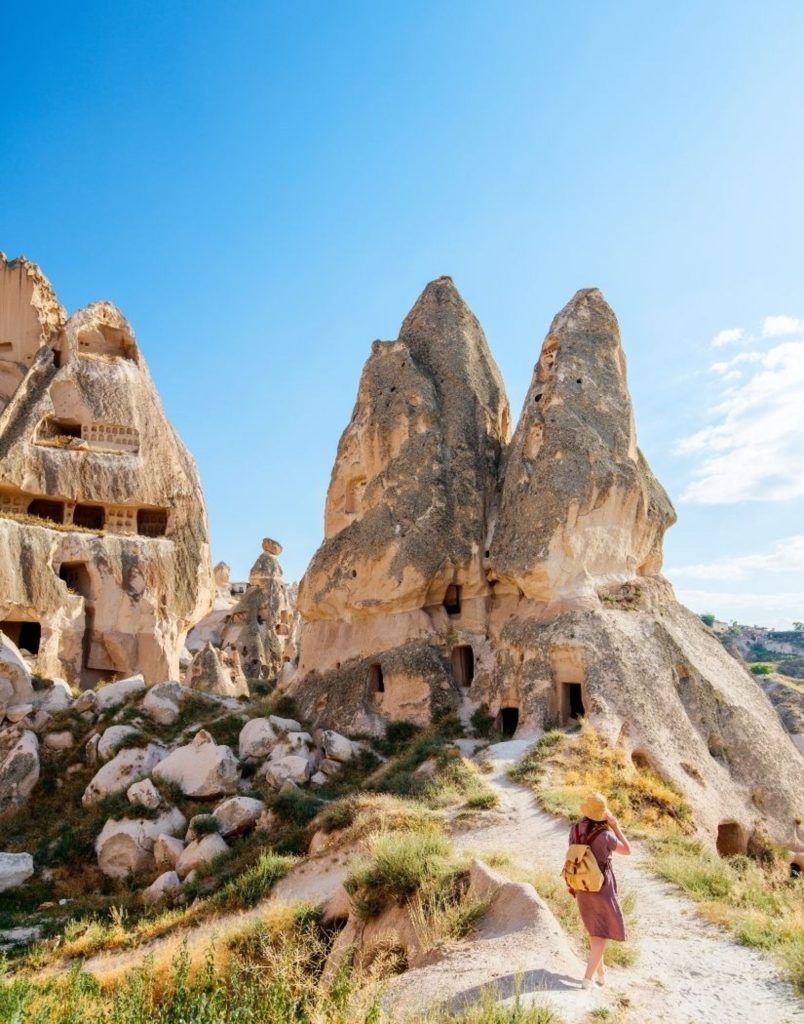 Cappadocia fairy chimney trail walking path with ancient cave houses blue sky