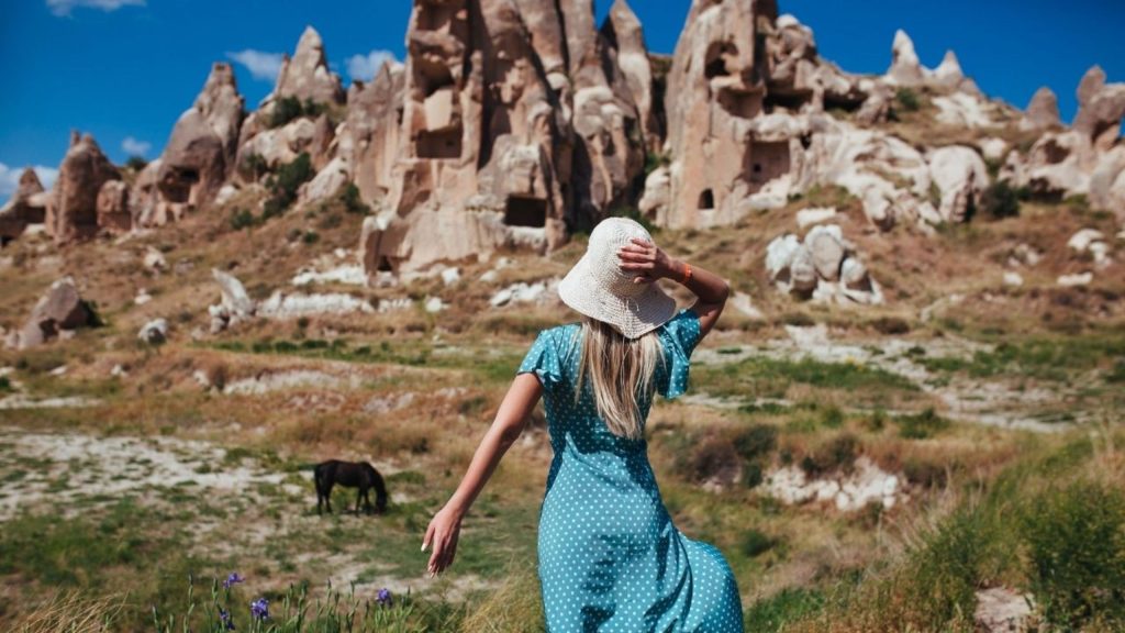 Cappadocia fairy chimneys and ancient cave dwellings in green valley landscape