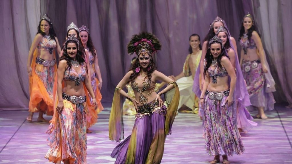 Female dancers in purple orange oriental costumes at Fire of Anatolia show Aspendos
