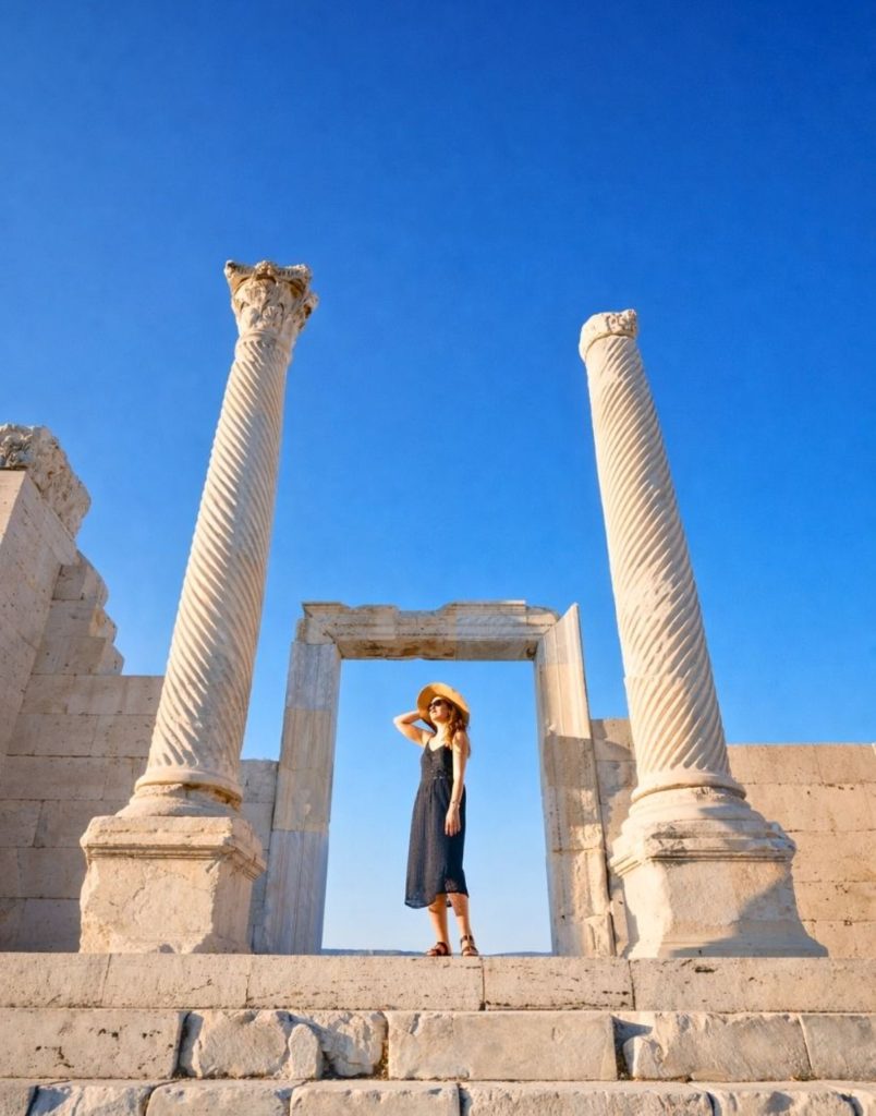 Hierapolis ancient spiral columns and gateway ruins against blue sky Pamukkale