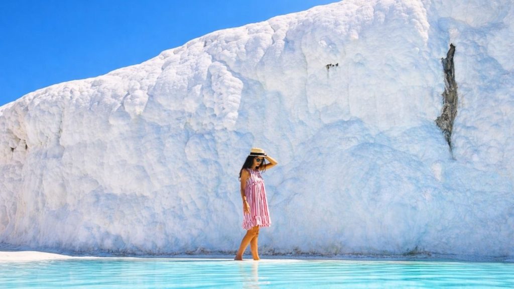 Pamukkale white travertine terraces with turquoise thermal pool close up UNESCO site