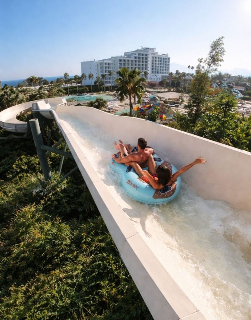 water hill aquapark high speed slide descent on inflatable tube with park and sea view