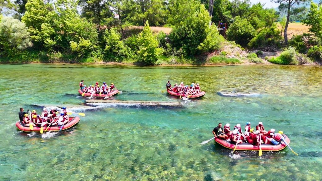 Antalya Koprulu Canyon aerial view multiple rafting boats on crystal clear turquoise water