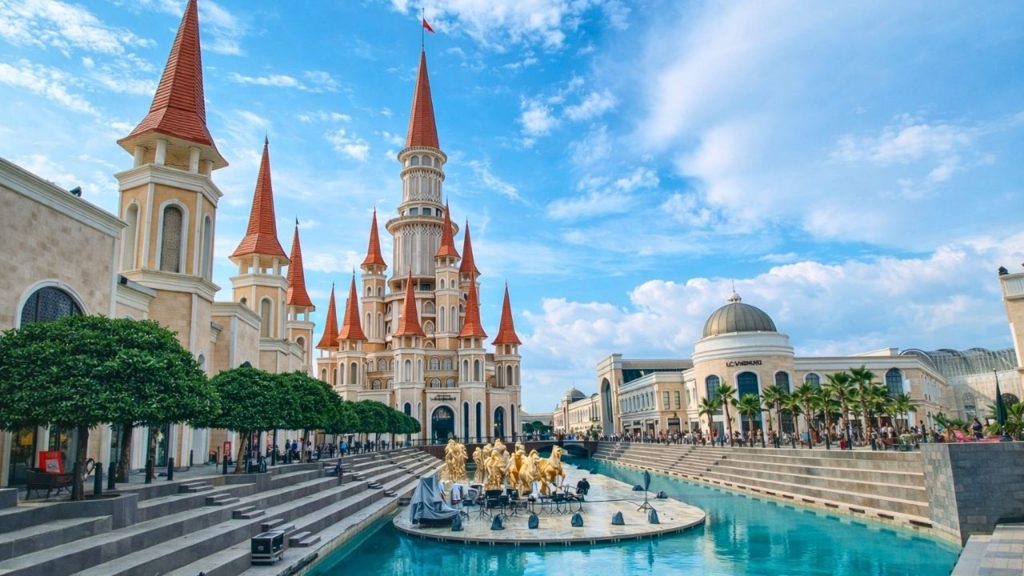 Land of Legends theme park castle with golden horse statues and water canal