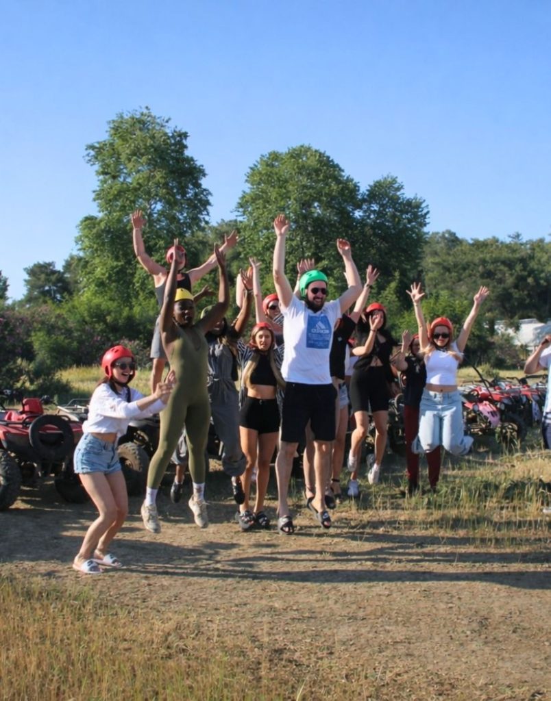 Happy group jumping together after quad biking safari adventure in Antalya