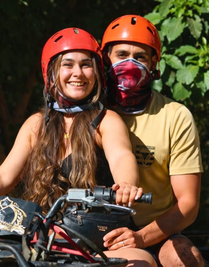 Couple enjoying tandem quad bike ride with helmets on Antalya safari tour