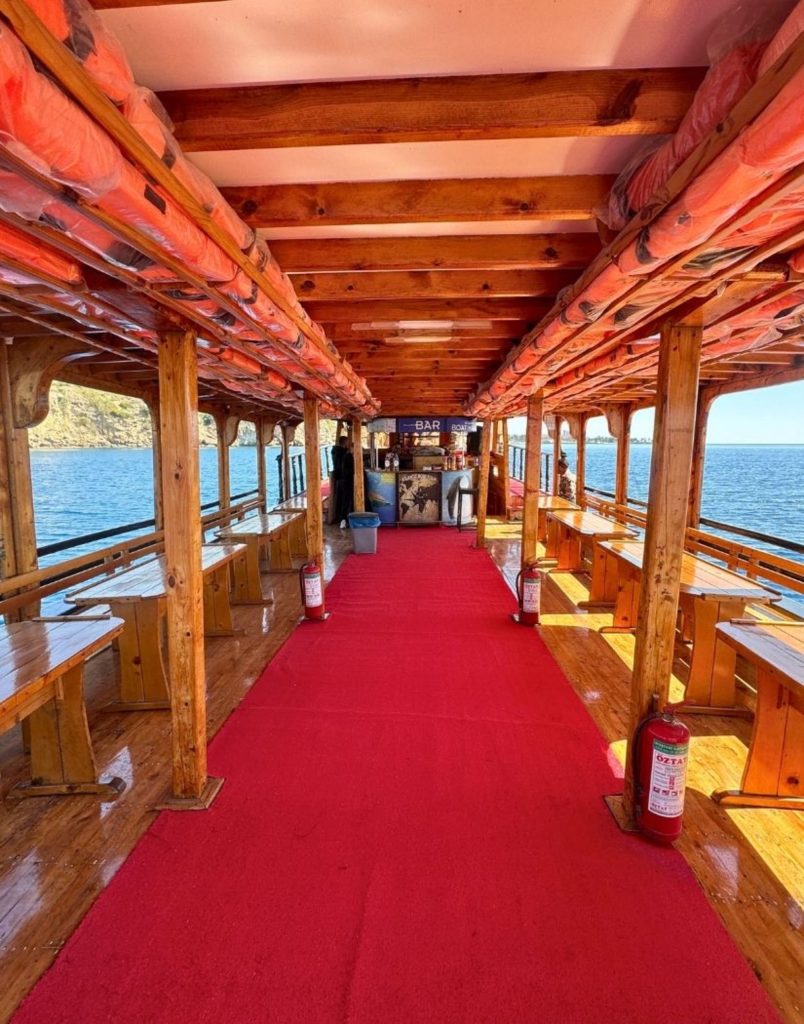 Comfortable wooden interior with bar inside Antalya Waterfall Boat Trip tour boat
