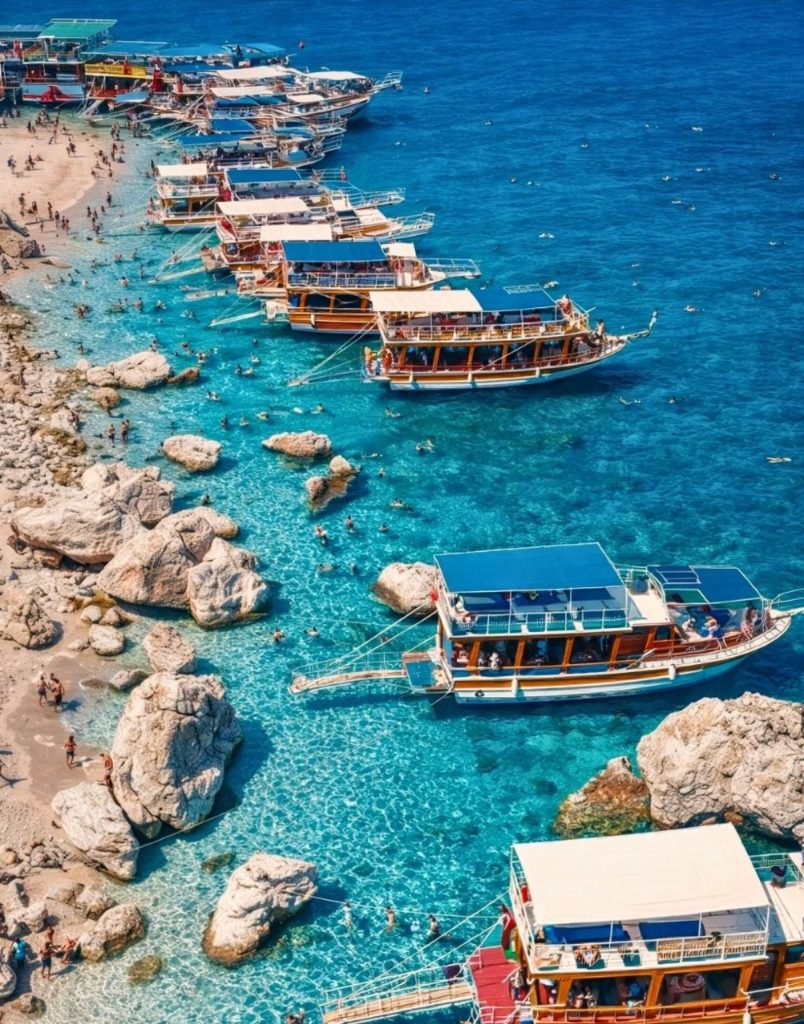 belek suluada boat tour aerial view of tour boats in turquoise bay with rocky coastline