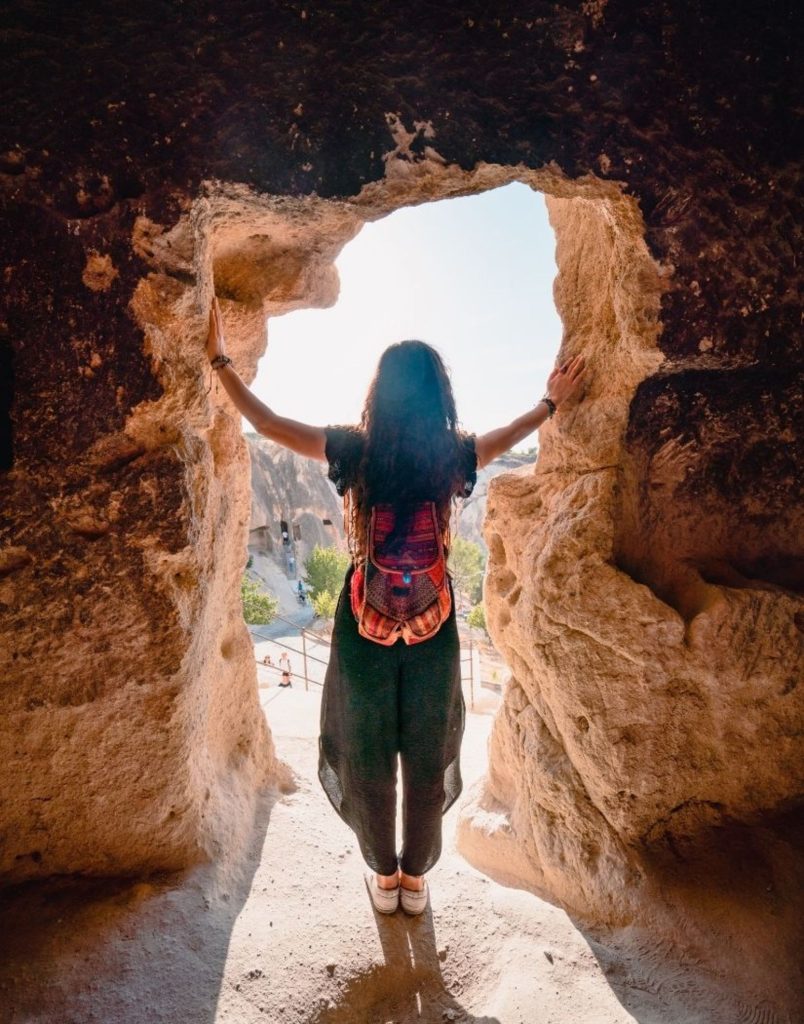 Looking through carved rock window at Cappadocia valley landscape
