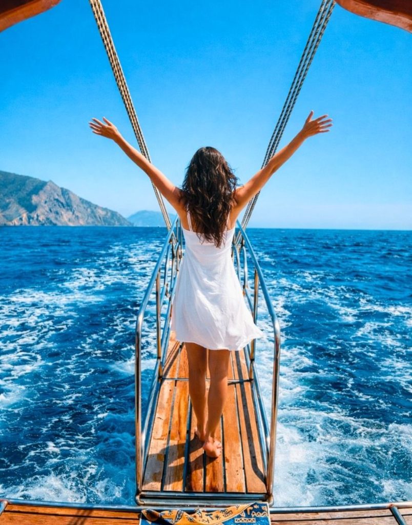 Sailing on open Mediterranean towards Suluada Island with mountain views during boat trip from Antalya