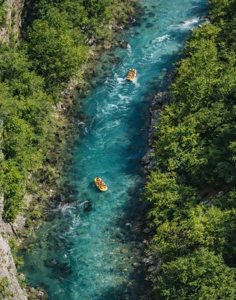 belek rafting aerial view of turquoise canyon river with two rafts between green forests