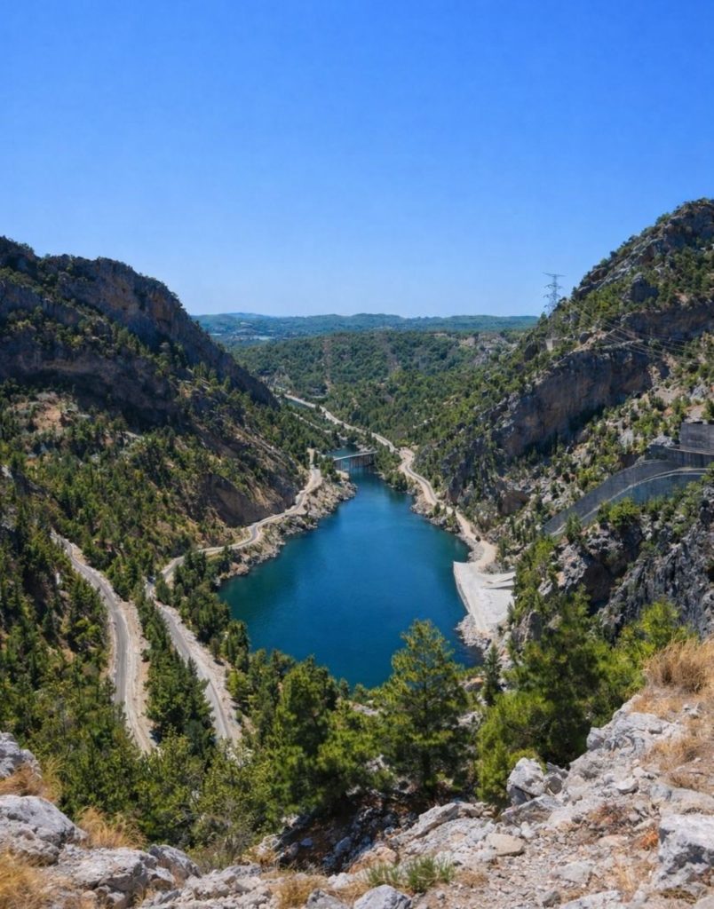Aerial view of Oymapinar Dam blue lake between green mountains near Alanya