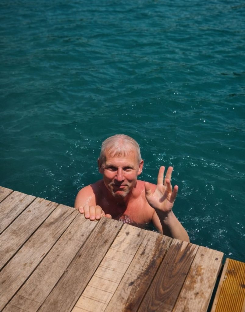 Visitor enjoying a refreshing swim in crystal-clear turquoise water at Green Canyon