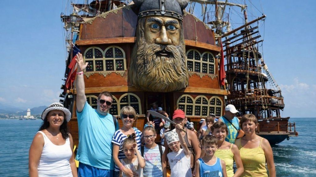 Family group photo in front of Viking pirate boat with carved viking head in Alanya