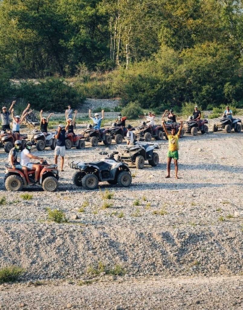 Quad safari group at river bed stop surrounded by green nature in Alanya