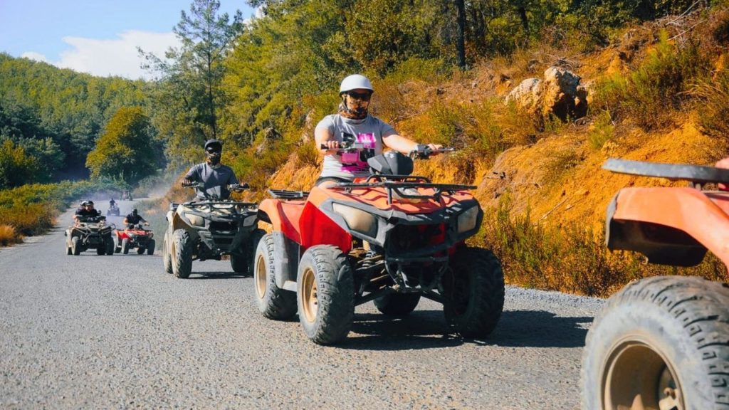 Group of quad bikes riding through mountain road in Alanya Taurus forest