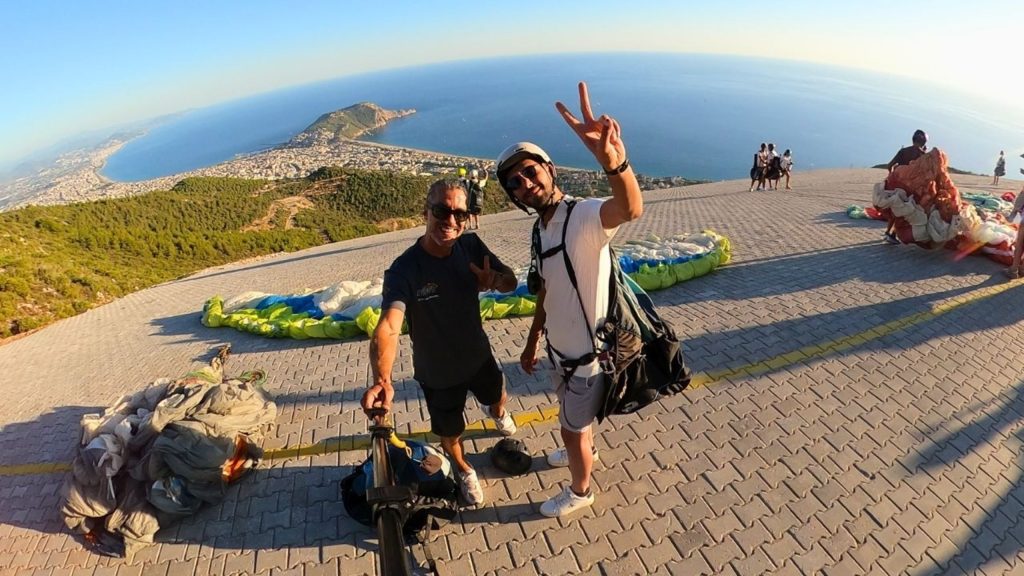 Pilot and passenger ready for tandem paragliding at Alanya mountaintop launch area