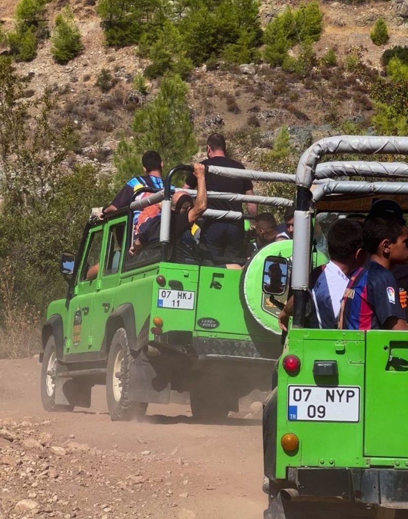 Close-up of jeep safari vehicles on dusty off-road trail in Antalya mountains