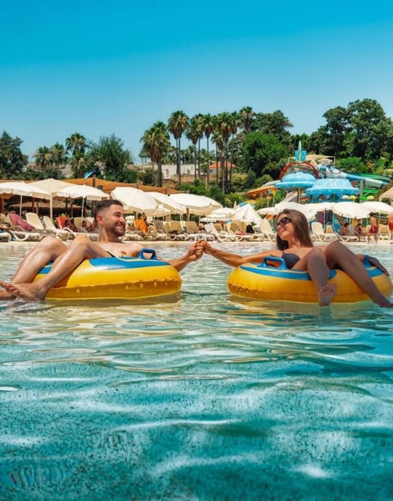 Floating on lazy river under palm trees at Water Hill Aquapark in Antalya